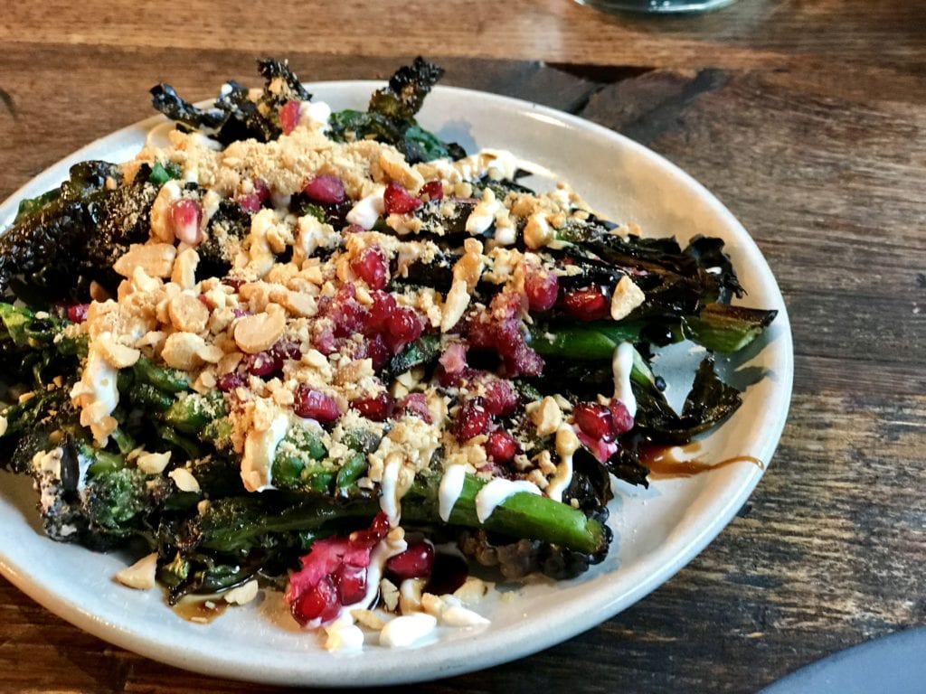 Charred greens with tahini, pomegranate and peanut at Smokestak in Shoreditch